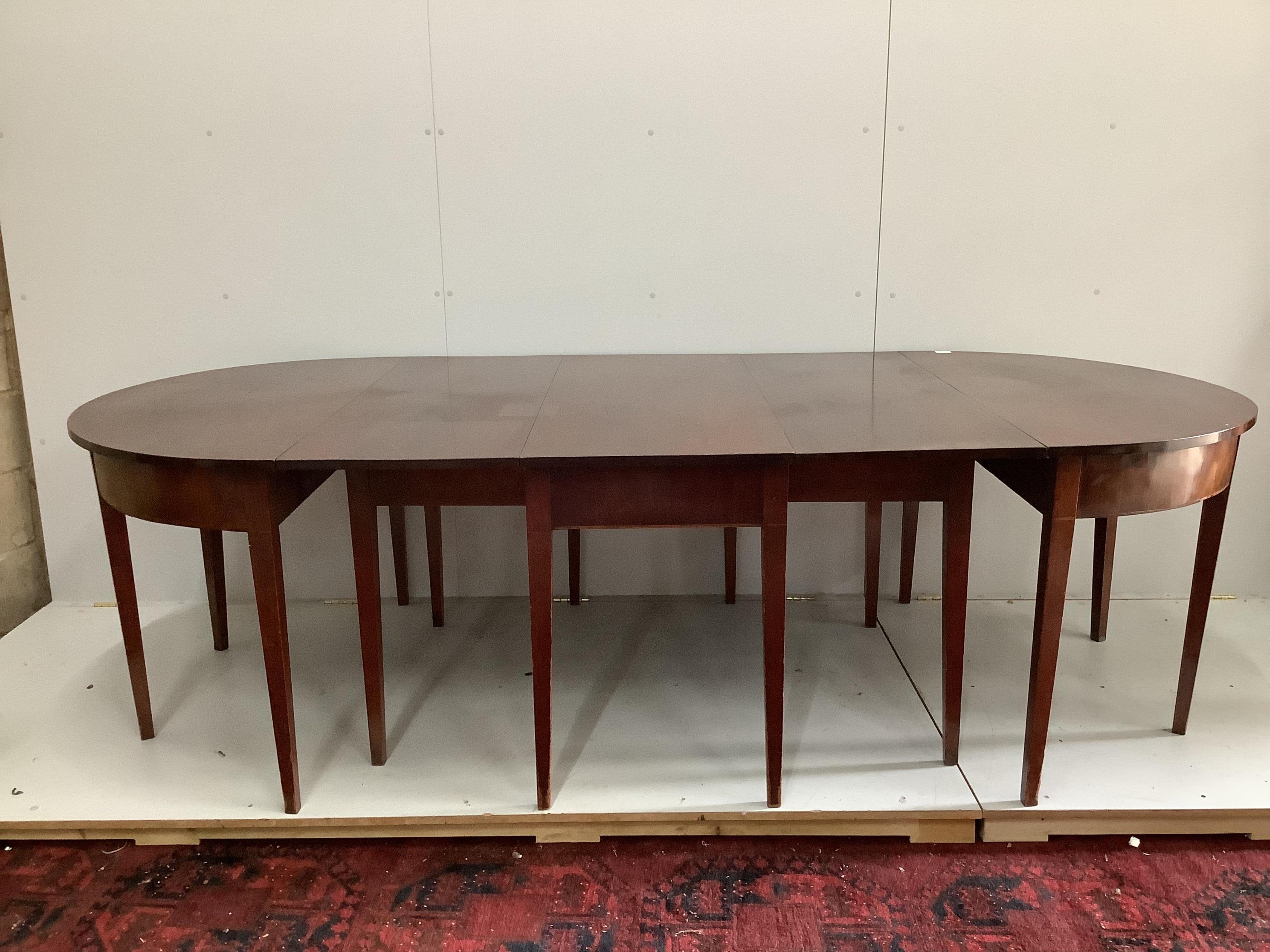 A George III mahogany D-end extending dining table, width 170cm, depth 120cm, height 73cm. Condition - fair